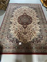 Full view of rectangular Persian style wool rug showing central medallion and entire patterning.