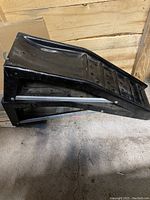 Side angle showing the inclined surface and structure of one black plastic car ramp.