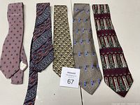 Photo showing all five silk ties laid out flat, showing their colors and patterns.