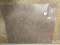 Clear rectangular plastic carpet protector mat on carpeted floor, angled, showing texture and condition