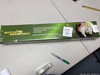 Box packaging of the Multi Cat window hammock perch showing product details and a cat resting on the hammock.