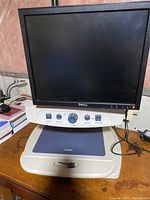 View of the Enhanced Vision Merlin device with Dell monitor and control base unit showing controls and size.