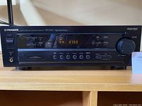 Front view of Pioneer VSX-D307 A/V receiver showing all buttons, display, and volume knob.