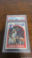 Front view of the 1989 Hoops Magic Johnson basketball card in PSA protective slab showing grade 6 EX-MT condition with red and white PSA label.