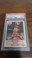 Front view of graded 1990 Fleer Michael Jordan basketball card #26 in PSA holder showing grade 6.