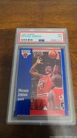 Front view of the 1991 Fleer Michael Jordan basketball card encapsulated by PSA with grade NM 7