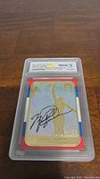 Front view of the 1998 Fleer Michael Jordan 23kt Gold Prism Holo Refractor Signature Series card graded WCG 10 Gem Mint with holographic effect and autograph.