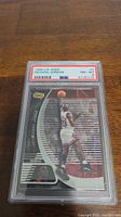 Front view of 1998 Upper Deck JONIX Michael Jordan basketball card #3 graded PSA 8 in protective slab.