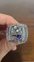 Top view showing Patriots logo, 'WORLD CHAMPIONS' text and rhinestones on the ring.