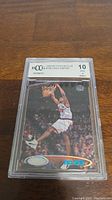 Front of 1998-99 Vince Carter rookie card graded BCCG 10 showing the dunk action image and holographic foil accents.