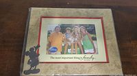 Image of the full photo frame with a family picture, showing the Mickey Mouse silhouette and quote "The most important thing is family."