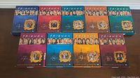 View of all 9 Friends DVD cases for seasons 1-4 and 6-10 showing colorful fronts with cast images and season numbers.