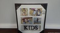 Full view of the kids picture frame showing four photo slots with children's pictures and 'KIDS' text below.