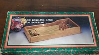 Close-up photo of the mini wood bowling game box showing the full packaging with an image of the game setup.