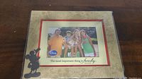 Full image of the 4x6 photo frame with family photo, Disney logo, and text "The most important thing is family".