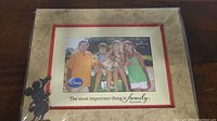 Photo showing the full front of the Disney themed frame with family photo and Mickey Mouse figure
