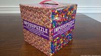 Box of Impossipuzzle showing colorful candy heart sides and brand name.