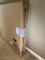 Box of the dog crate kit displayed standing upright showing crate size and SKU details on the side.
