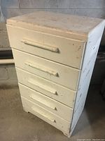 Front view of the vintage 5-drawer solid wood dresser showing white painted surface with chipping and wear.