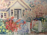 Close-up photo of the watercolor painting showing details of the house, window, gate, and colorful flowering garden.
