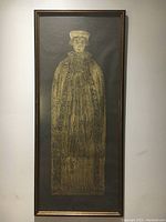 Full view of the vertical framed brass memorial of John Hygden showing the entire engraved figure and frame.