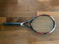 Top view of Wilson Surge tennis racket showing frame and grip.