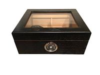 Black wooden rectangular humidor with glass top, showing wood texture and hygrometer on front.