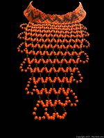Front view of the orange and black beaded bib necklace displayed on a black mannequin, showing the wide collar and dangling beaded fringe.