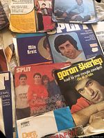 Close-up image showing several vintage 45 RPM record covers featuring European artists like Goran Škerlep, Dara, Milo Hrnić, and others predominantly from the Balkan region, with visibly worn covers.