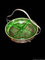 Top angle showing the bright green uranium glass divided into four sections inside the silver basket with an arched handle