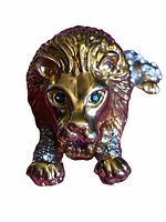 Front view of the vintage roaring lion brooch showing gold-tone metal lion face and blue rhinestone eyes.