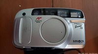 Front view of the silver Minolta Freedom Zoom 70 camera showing the autofocus and remote date markings.