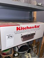 Photo of KitchenAid roaster box on shelf showing brand, size, and image of roaster with lift rack.