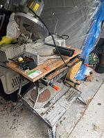 Wide shot showing the Workmate bench with mounted Concept MS100 sliding compound mitre saw, revealing the full setup and condition.