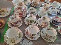 Group view of all month teacups and saucers arranged on table