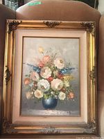 Frontal photo of the framed floral painting showing entire artwork and frame.