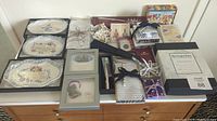 Full lot overview showing memo pads, note cards, decorative dishes, and New York Times jigsaw puzzle on dresser.