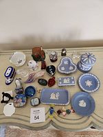 Overview of all Wedgwood jasperware and various collectible miniatures on table including glass, ceramic, and crystal items