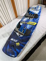 Show full view of the blue Blindside Model DVS wakeboard with attached shoes, highlighting the board's top surface and foot bindings.