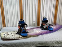 Full view of Hyperlite wakeboard with attached extra large boots showing board design and colors.