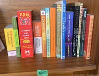 Full view of 14 paperback books arranged vertically, visible titles include self-help and general knowledge titles with a variety of colored spines.