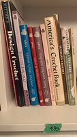 Shelf showing 10 crochet books with mostly softcover and some hardcover, spines visible for title identification.