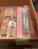 Photo of incense sticks and incense burners in tray showing package brands and items