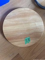Top view of the round wooden Lazy Susan showing smooth wood grain surface.