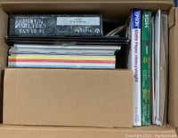 Top down photo of open box containing various packages of paper and card stock including Epson Matte Paper Heavyweight and others