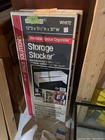 Box showing product name, dimensions (12"D x 11.5"H x 31"W), and usage as stackable space organizer.