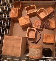 Top down view showing all nine wooden boxes arranged in a drawer including the six maple burl boxes and three others