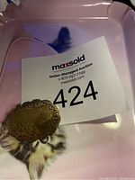 Front of vintage sterling silver brooch showing ornate engraved designs and scalloped edges. Vintage style.