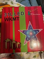 Red and green Christmas-themed box with star shape and 31 LED WKMT Christmas light text