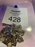 Front side view of the vintage silver floral brooch with hallmarked 1793, showing detailed petal design and layered construction.